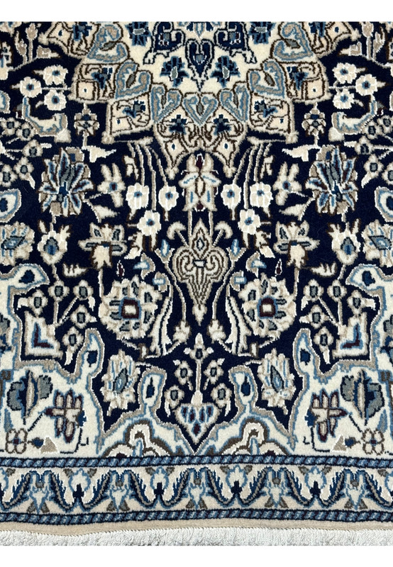 Detailed view of the lower part of a 3x5 Nain Persian rug showing intricate motifs