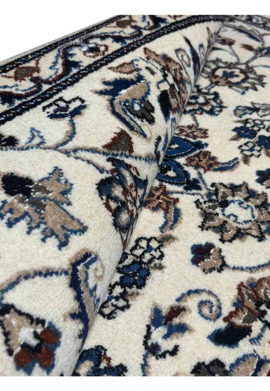 Rolled view of 3 x 4'4 Persian Nain Rug highlighting the fine wool and silk blend and detailed craftsmanship.