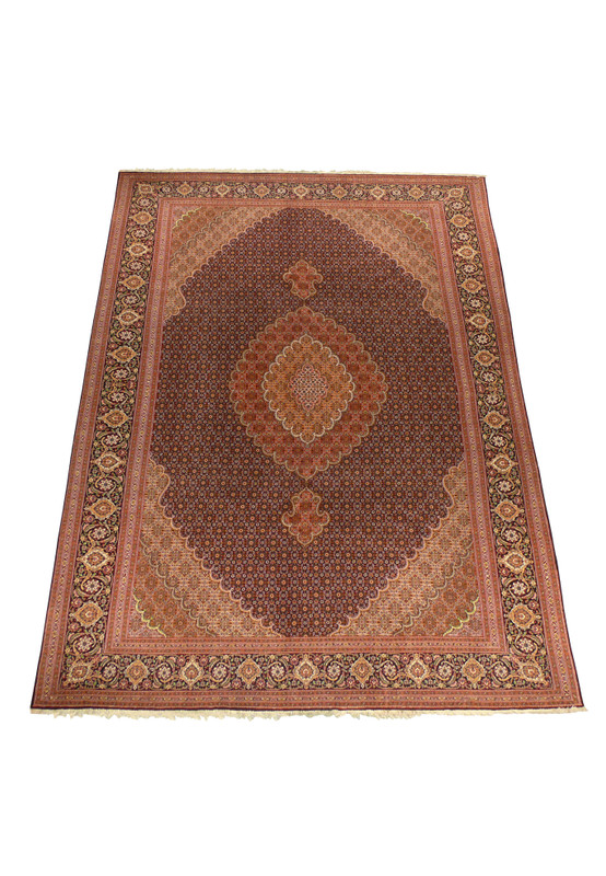 Persian Tabriz Mahi Rug laid flat showing vibrant red and beige details.
