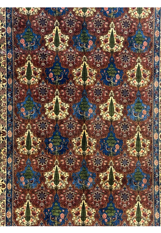 Close-up of the midfield floral design on a Persian Bakhtiar Rug, showcasing detailed trees, leaves, and bird motifs.