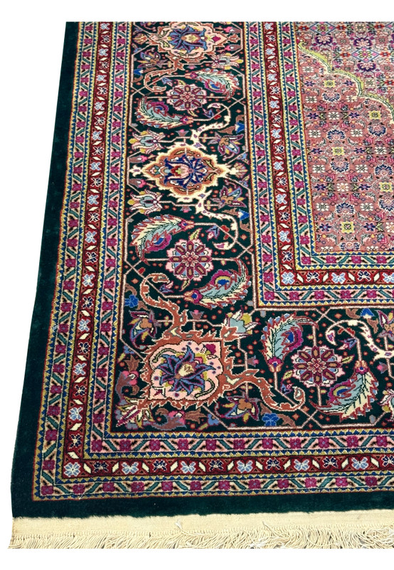 Lower border of the Oriental Tabriz Rug, with floral motifs and vibrant contrasting colors.