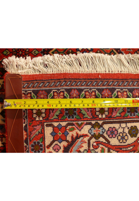 Close-up back knots and fringe with measuring tape indicating knot density on Bijar Persian rug.