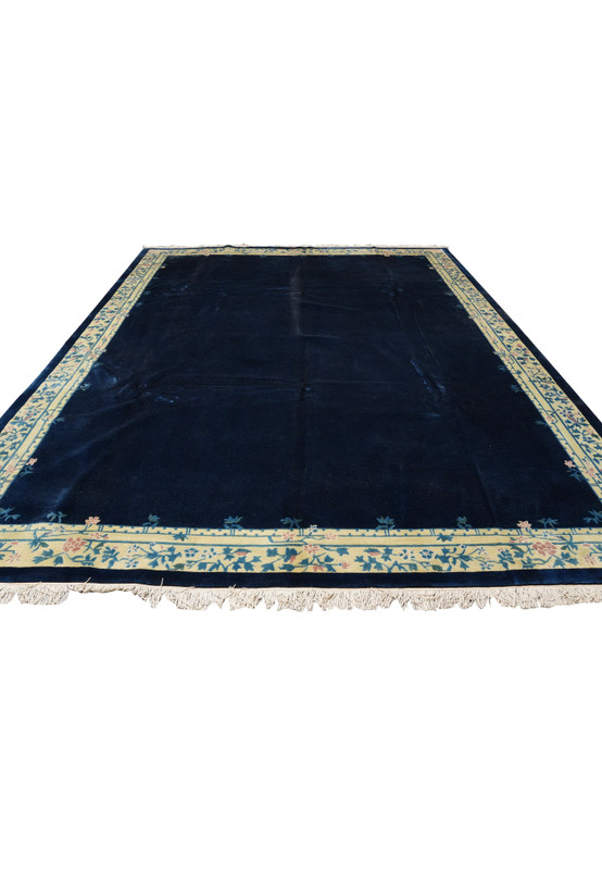 Front view of navy blue Beijing Art Deco rug hand-knotted in wool with floral border.