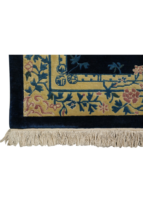 Detailed floral border of Beijing Art Deco rug with pastel blossoms on ivory frame.