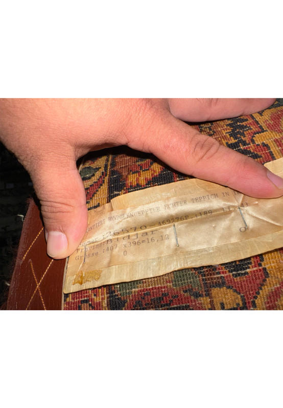 Back of antique Bijar rug with original European import label and wool foundation visible