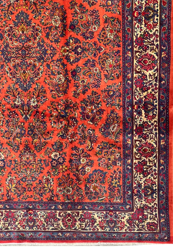 Persian Sarough rug border with ivory ground, navy and red floral sprays, framed by blue guard borders, hand-knotted wool craftsmanship.