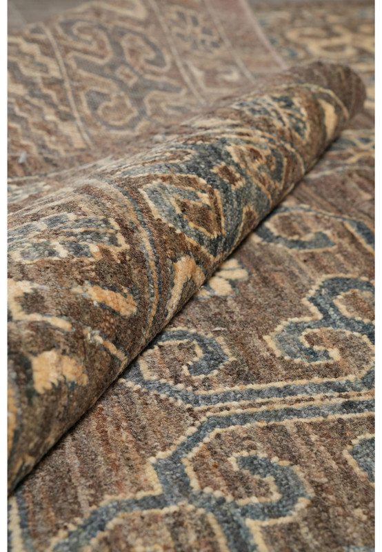 Zigler Transitional Rug rolled corner highlighting wool pile, earthy brown and grey tones with beige accents.