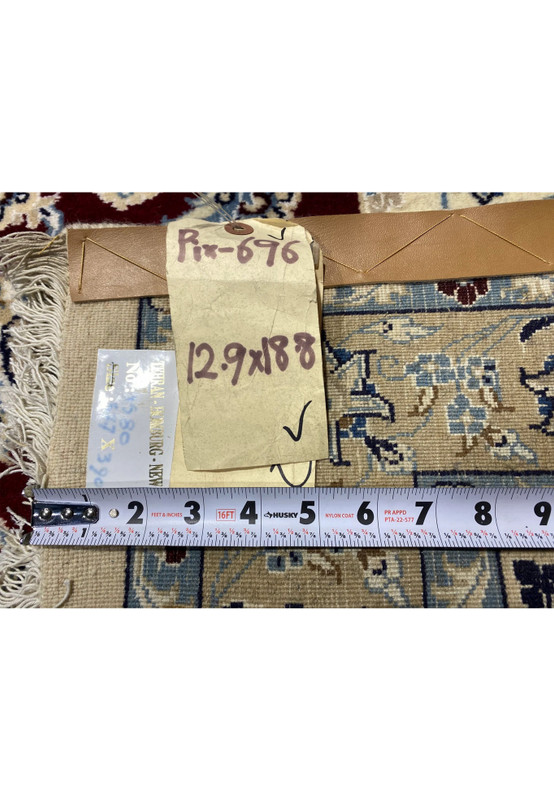 Backside and tag of 12'9 x 18'8 Red Persian Nain 9 LAA wool and silk rug showing handwritten label, measurement tape, and weave detail