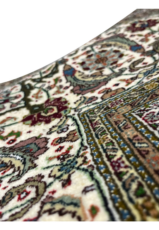 Corner of Tabriz 50 Raj Square Rug showing scalloped design, rust and olive tones blending into the deep wine red field