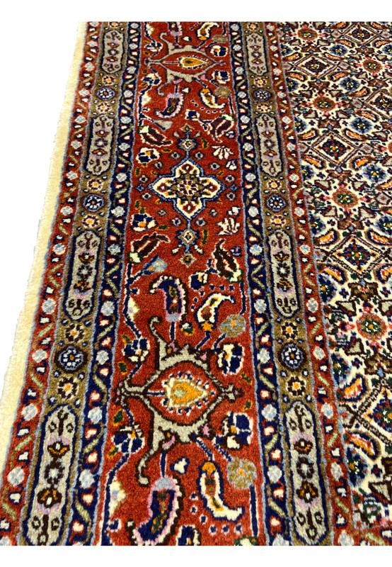 Side border close-up with geometric motifs, rosettes, and vine scrolls.