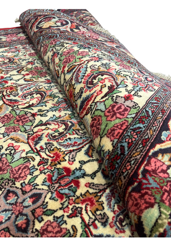Rolled view showing wool texture and floral detail of Bijar Halvaie Rug