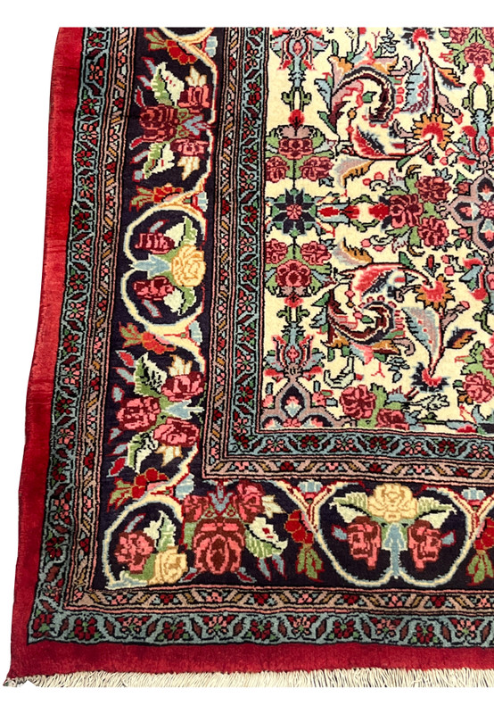 Close-up of navy floral border with roses and cartouches on Bijar Halvaie Rug