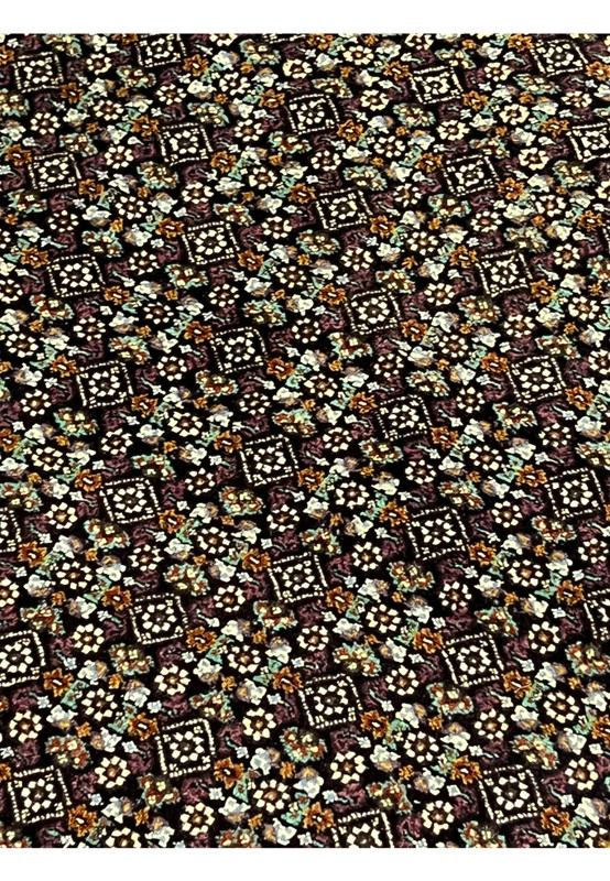 Close-up of the iconic Mahi fish motif repeated in the field of Tabriz rug