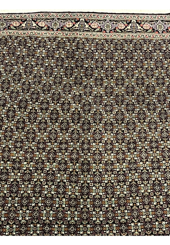 Close-up of repeating diamond lattice field with Mahi motifs on Tabriz rug