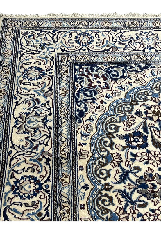 Upper edge view of Square Persian Nain Rug with ivory and navy border pattern