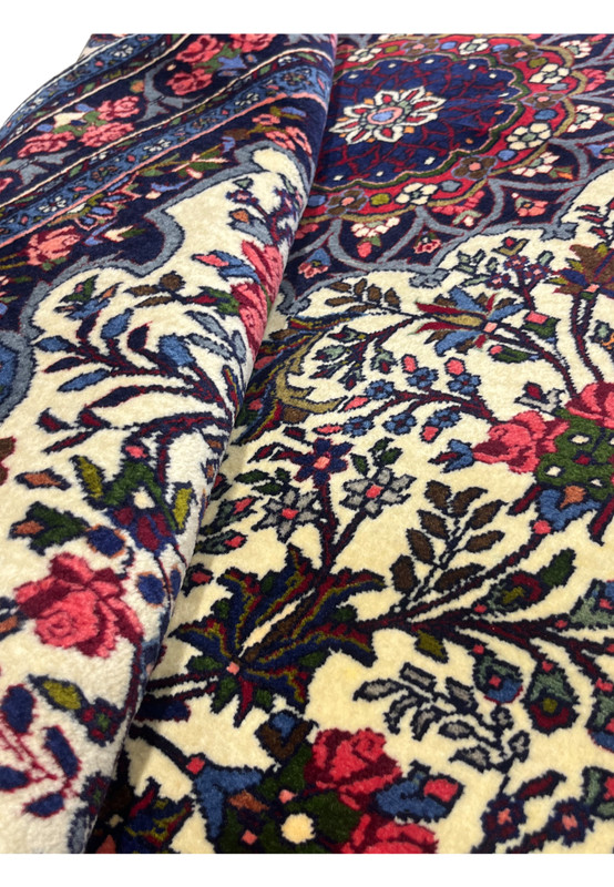 Rolled view of 4'3 x 6'8 Persian Bijar Rug with visible floral motifs and dense wool pile