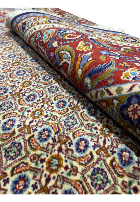 Rolled Persian Moud rug highlighting pile quality and border design