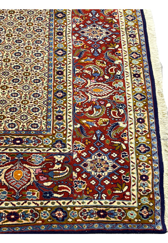 Close-up of Persian Moud rug border with terracotta and floral designs