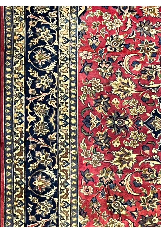 Side border detail featuring navy vines, beige flowers, and refined Isfahan craftsmanship.
