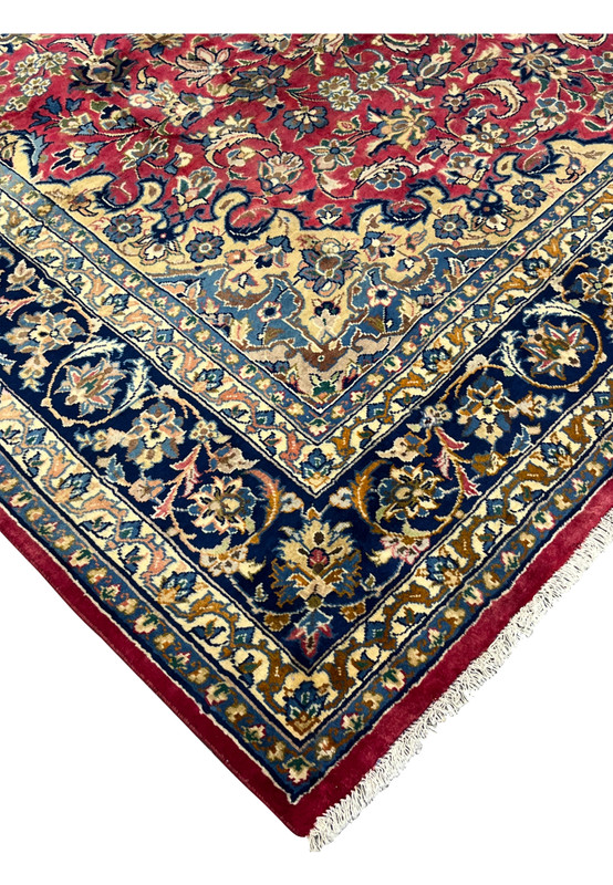 Angled corner view highlighting the rug’s dense pile, fine knotting, and aged patina in traditional Isfahan artistry.
