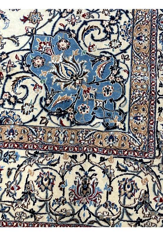 Inner border of Persian Nain 4 LA Habibian rug with soft ivory base, blue arabesque floral patterns, and golden accents woven in dense 4 LA knot work.