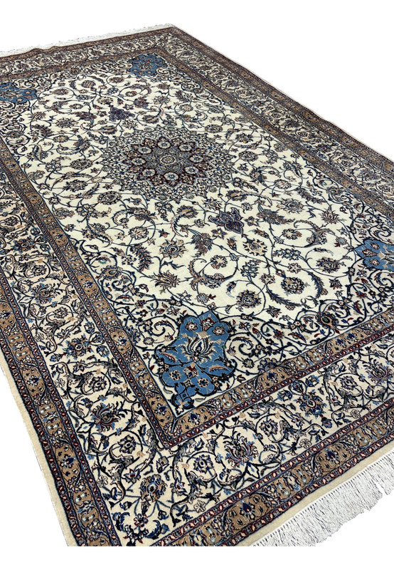 Angled full-view photo of signed Persian Nain 4 LA Habibian rug, highlighting hand-knotted wool and silk texture and finely balanced color palette.