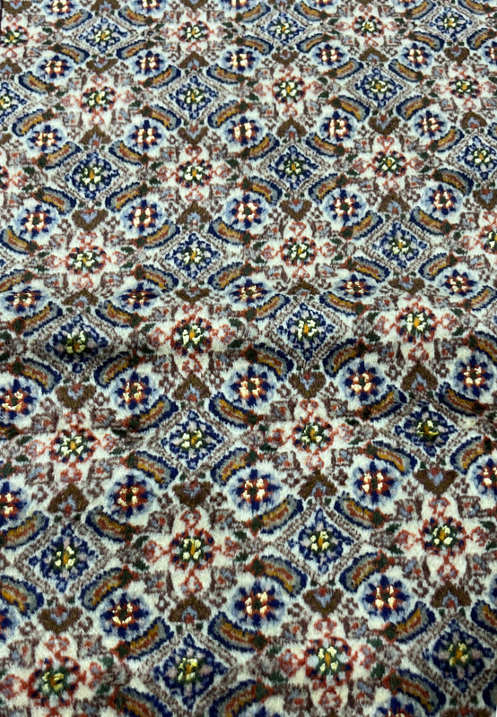 Detailed Herati fish pattern with blue rosettes and olive-green leaves on ivory field of Moud rug.