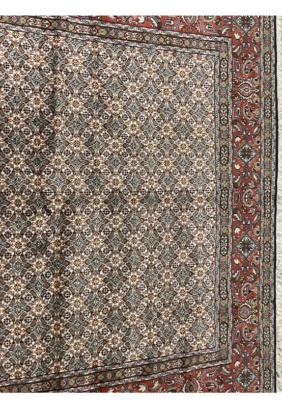 Close-up of all-over Moud Herati design with ivory, blue, brown, and red tones in fine wool texture.