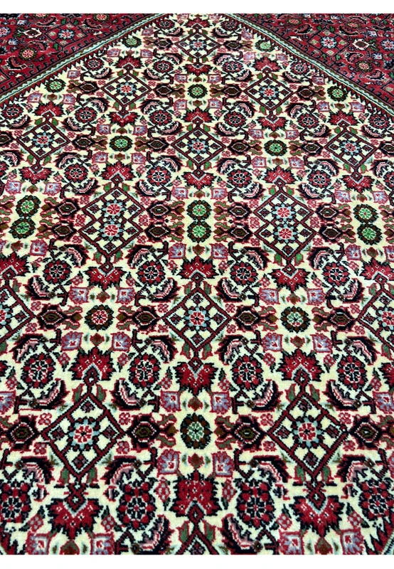 closeup of 10x13 Bijar Persian rug medallion showing intricate red, ivory, and green motifs