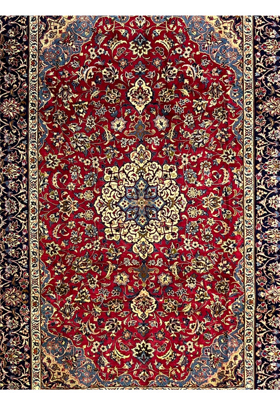 Central field of 8'5 x 11'8 Persian Isfahan rug showing red wool background and floral medallion symmetry.