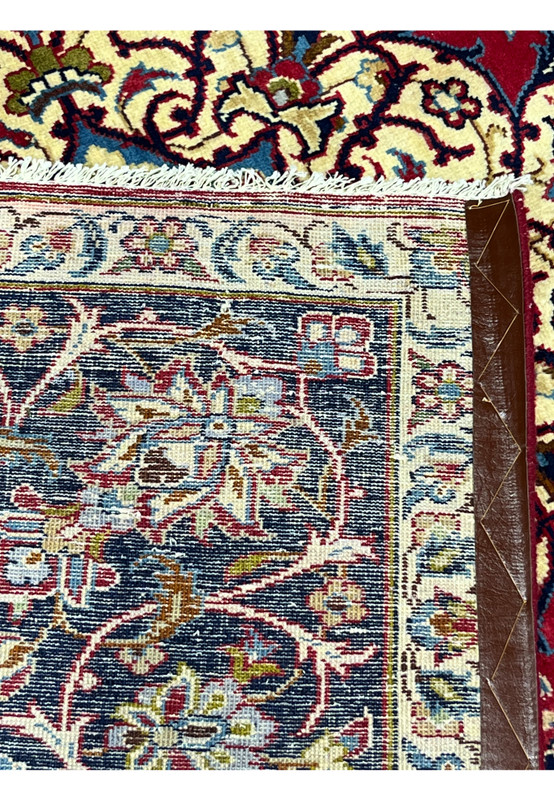 Backside of 8'5 x 11'8 Persian Isfahan rug showing tight hand-knotted wool on cotton foundation.
