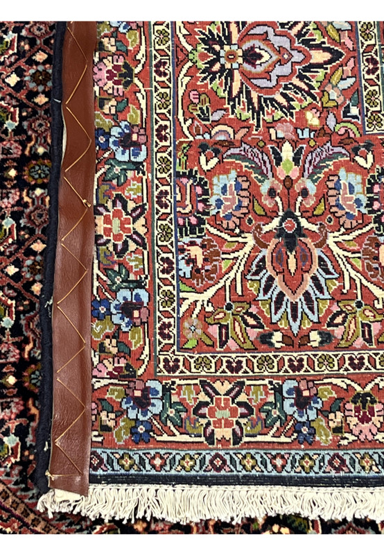 Reverse side of the Persian Bijar rug displaying border florals, geometric motifs, and sturdy wool foundation.