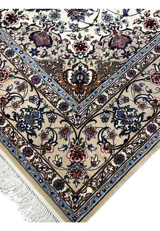 Detailed corner and fringe view showing beige borders, blue accents, and fine floral work of the Isfahan rug.
