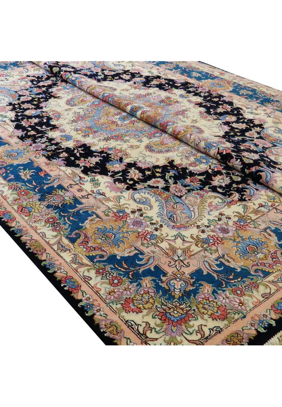 Angled view of the Tabriz rug showing wool-and-silk sheen, floral detailing, and medallion depth.