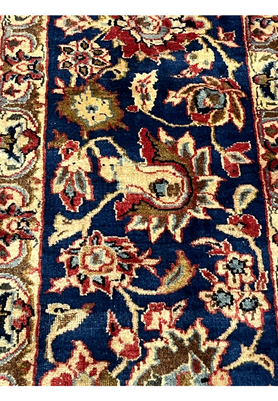 Edge shot of the vintage Najafabad Persian rug showing the border design, fringe, and wool pile texture.