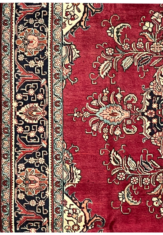 Side view of the 10x13 Patina Vintage Tabriz Rug showing worn areas, floral designs, and border contrast.