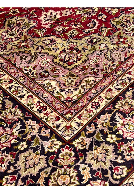 Inner border floral pattern of red Persian Isfahan rug with cream guard bands