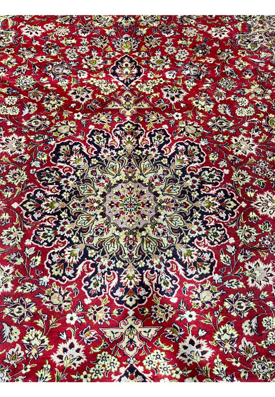 Closeup of central floral medallion on red Persian Isfahan rug in excellent condition”