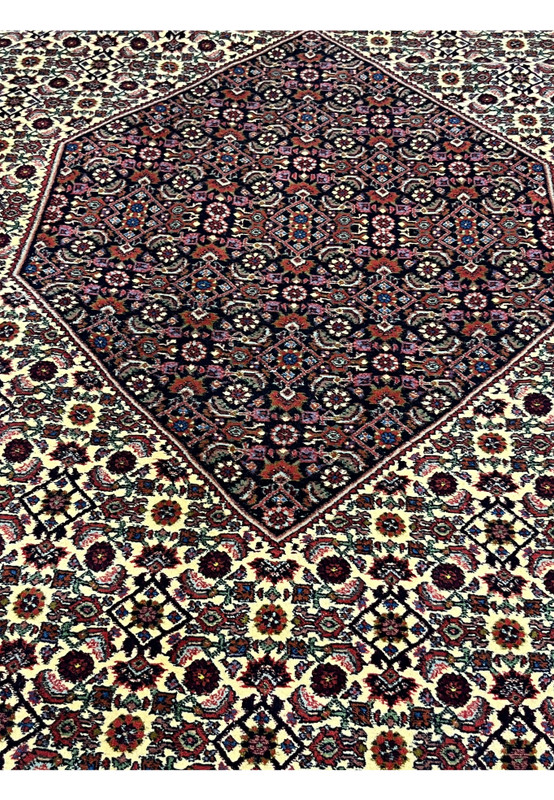 Central diamond medallion close-up of Persian Bijar rug with ivory surround