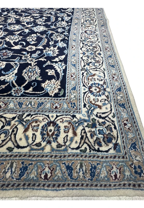 Main border of square Persian Nain rug with repeating floral medallions, vine scrolls, and finely balanced color palette
