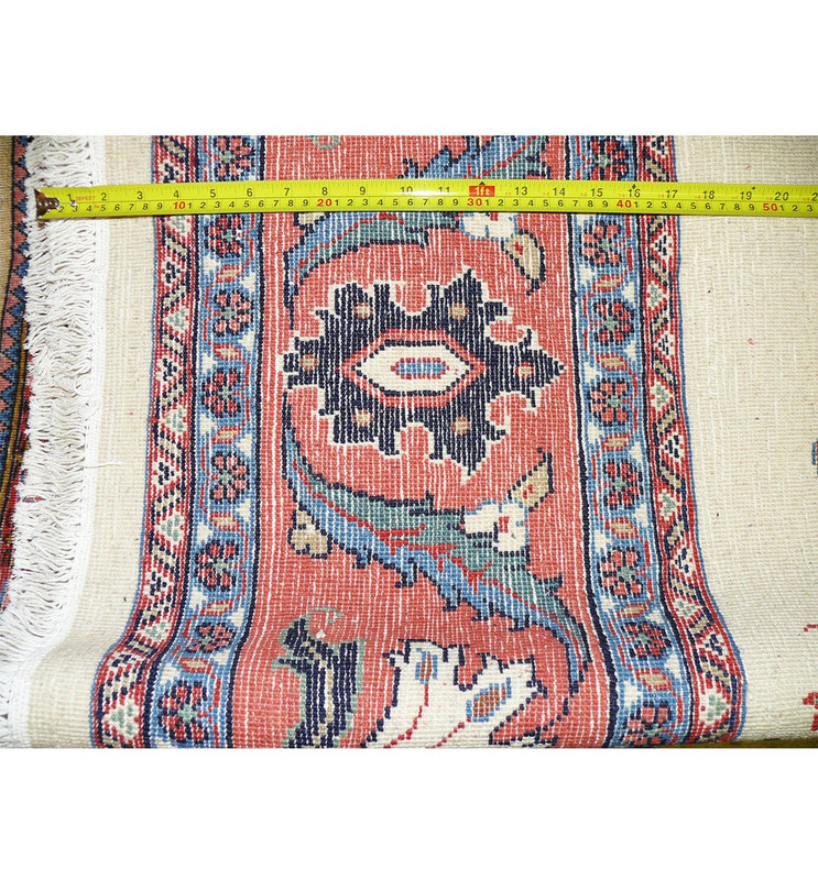 Back of a hand knotted Persian Farahan rug with ruler measuring knot density, visible cotton foundation, and clear pattern structure
