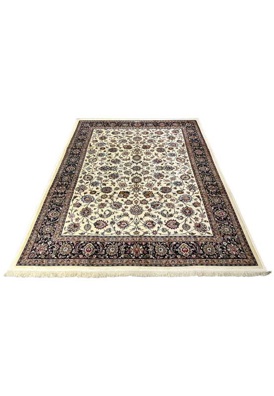 Top view of signed Persian Mashad Saber rug highlighting balanced allover floral pattern