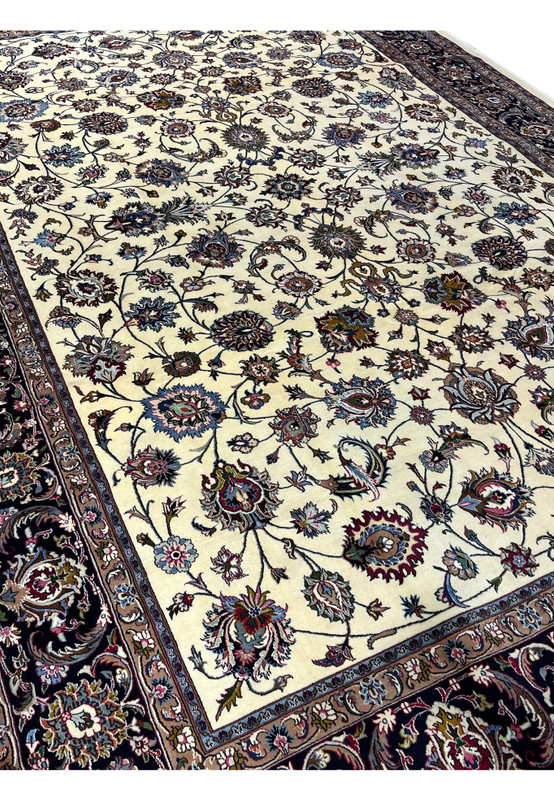 Close-up of ivory field floral motifs in signed Persian Mashad Saber rug
