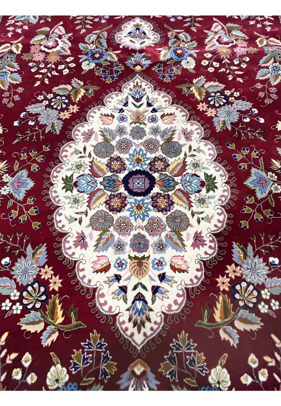 Close-up of ivory central medallion on Persian Isfahan rug with intricate silk floral detailing