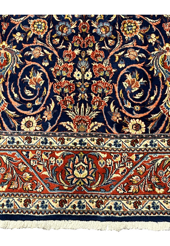 Close-up of red and ivory floral border on Persian Sarough rug