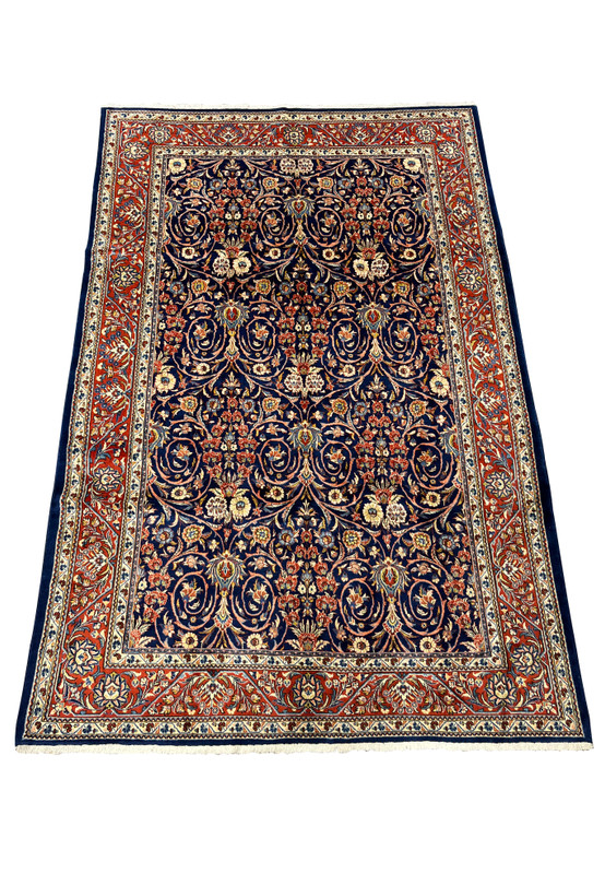 Top view of Persian Sarough rug showing navy blue field and balanced floral motifs