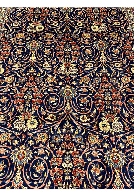 Central floral arrangement detail on navy Persian Sarough rug