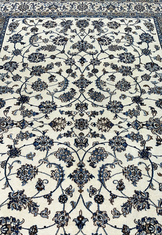 Midfield closeup of Persian Nain rug showing silk highlighted floral rosettes