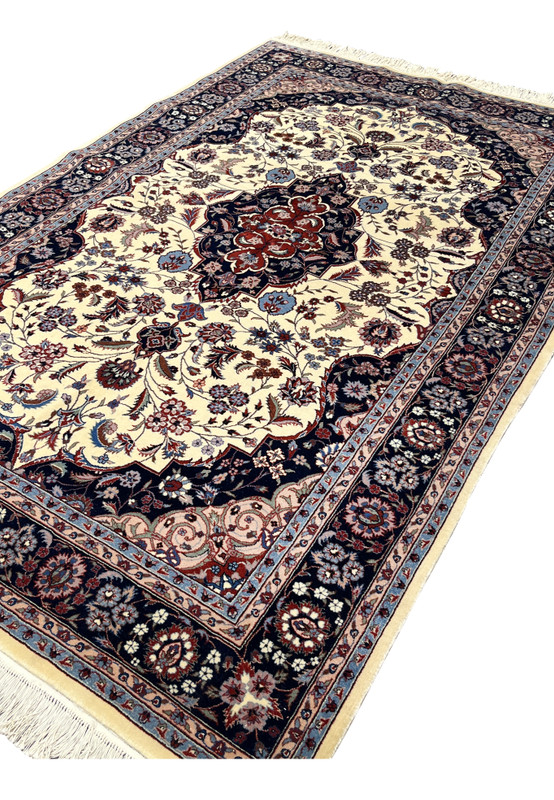 Angled view of 5x8 Persian Tabriz rug revealing pile texture, depth, and color contrast