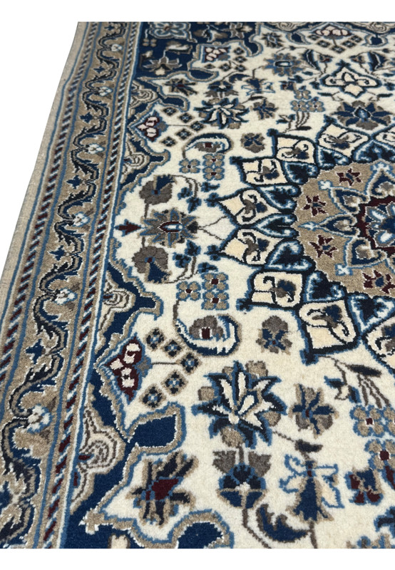 Cotton foundation and fine knot structure visible on back of Persian Nain rug
